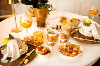 a table topped with plates of food and glasses of wine at VATICANO 13 Guest House in Rome
