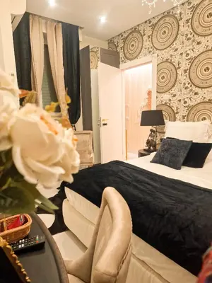 a bedroom with a bed and a table and flowers at VATICANO 13 Guest House in Rome