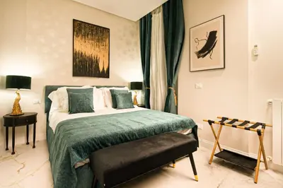 a bedroom with a bed with a green blanket at VATICANO 13 Guest House in Rome