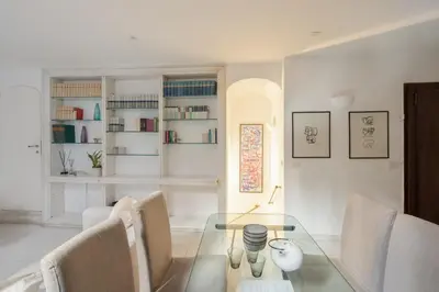 a dining room with a glass table and chairs at Maison Barchetta in Via Giulia in Rome