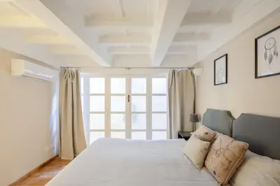 a bedroom with a bed and a large window at Maison Barchetta in Via Giulia in Rome