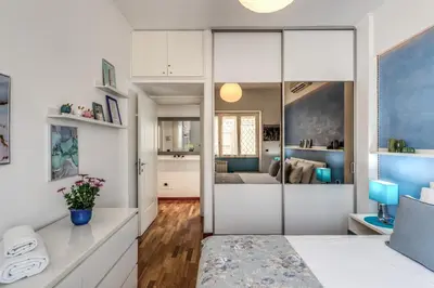 a living room with a sliding door leading to a bedroom at New York Apartment in Rome