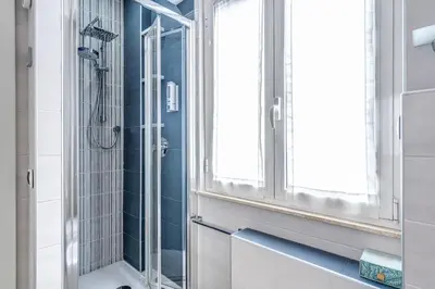 a bathroom with a shower and a window at New York Apartment in Rome