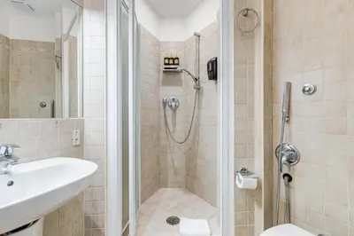 a bathroom with a shower and a sink at VIVILO COLLECTION - Marche 54 Apart 4bdr - Close to Via Veneto in Rome