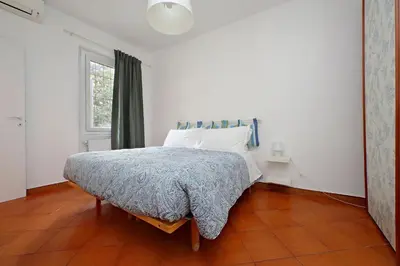 a bedroom with a bed and a window at Cinque in Rome