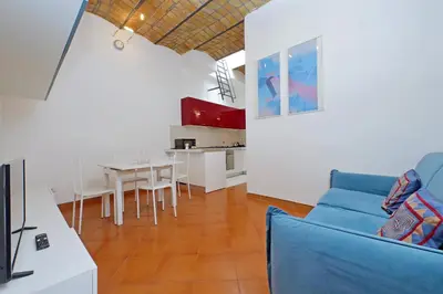 a living room with a blue couch and a table at Cinque in Rome