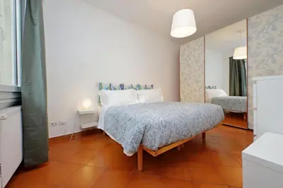 a small bedroom with a bed and a mirror at Cinque in Rome