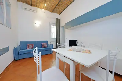 a living room with a white table and chairs at Cinque in Rome