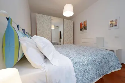a bedroom with a bed with pillows and a surfboard at Cinque in Rome
