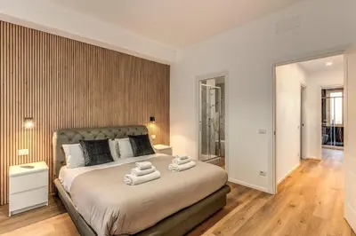 a bedroom with a large bed with towels on it at Vatican Private Apartment in Rome