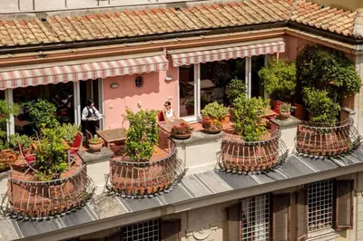 a group of potted plants on the side of a building at The Inn at the Spanish Steps Exclusive Collection - The Nest Penthouse in Rome