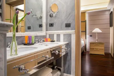 a bathroom with a sink and a mirror at The Inn at the Spanish Steps Exclusive Collection - The Nest Penthouse in Rome
