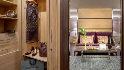 a room with a bed and a table with shoes at The Inn at the Spanish Steps Exclusive Collection - The Nest Penthouse in Rome