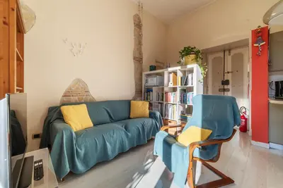 a living room with a couch and a chair at Casa Emma - Charme Holidays in Rome