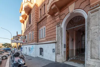 a building on a street with a motorcycle parked next to it at Casa Emma - Charme Holidays in Rome