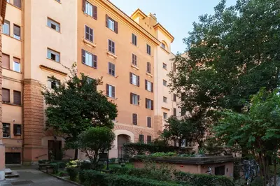 a large brick building with trees in front of it at Casa Emma - Charme Holidays in Rome