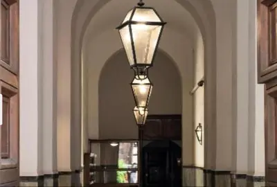 a large hallway with a light fixture in a building at La casa di Nina in Via Veneto in Rome