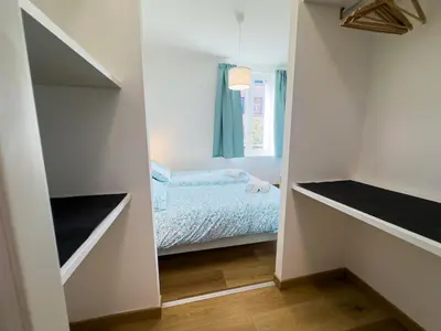 a small bedroom with a bed and a mirror at Laura's Rooms in Rome