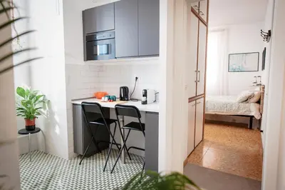 a small kitchen with a table and two stools at Laura's Rooms in Rome