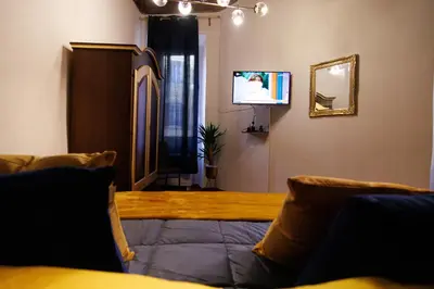 a living room with a couch and a tv at Crezy House Trilussa in Rome