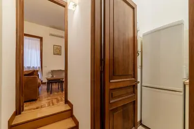 a wooden door in a room with a mirror at GuestHost - Charming Apartment near Piazza di Spagna in Rome