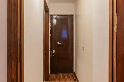 a hallway with a black door and a mirror at GuestHost - Charming Apartment near Piazza di Spagna in Rome