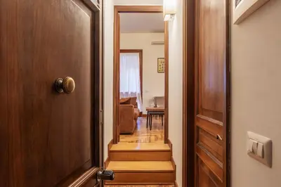 a hallway with a door leading to a living room at GuestHost - Charming Apartment near Piazza di Spagna in Rome