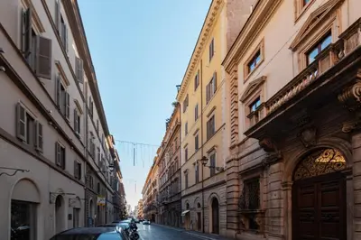 a city street with buildings and a car parked on the street at GuestHost - Charming Apartment near Piazza di Spagna in Rome