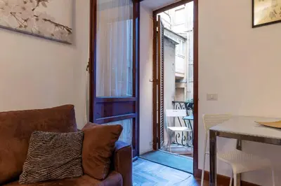 a living room with a couch and a table at GuestHost - Charming Apartment near Piazza di Spagna in Rome