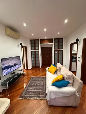 a living room with a white couch and a flat screen tv at Casa Turchina in Rome