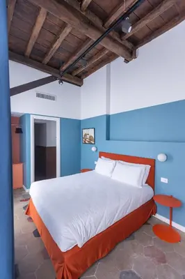 a large bed in a room with blue walls at Interno 12 in Rome
