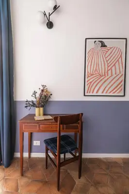 a desk with a chair and a picture on the wall at Interno 12 in Rome