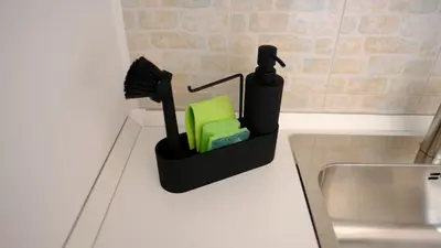 a kitchen counter with a brush and a sink at La Nuova Casa Di Zia - near metro A Ponte Lungo in Rome