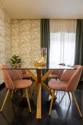 a dining room with a glass table and chairs at Morgana - Charming Apartment Close to Vatican in Rome