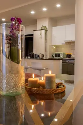a kitchen with candles on a glass table at Morgana - Charming Apartment Close to Vatican in Rome