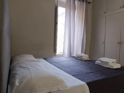 a bedroom with a bed and a window with towels at Trastevere Bertani MiniApartment in Rome