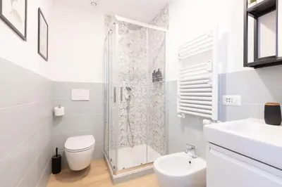 a bathroom with a shower and a toilet and a sink at Kimera42 Casa Vacanze in Rome