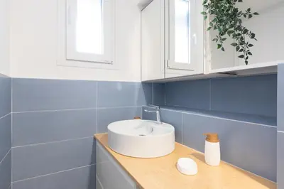 a bathroom with a white sink on a wooden counter at Kimera42 Casa Vacanze in Rome