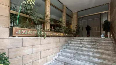 a building with stairs in front of a building with plants at Love of Rome in Rome