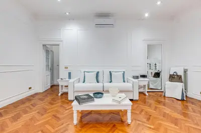 a living room with a couch and a table at New opening Spagna Suite in Rome