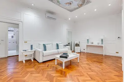 a living room with a couch and a table at New opening Spagna Suite in Rome