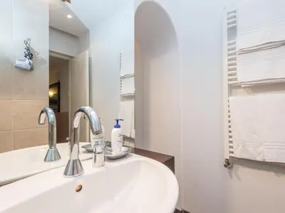 a bathroom with a sink and a mirror at Spacious 2BR in the historic center in Rome