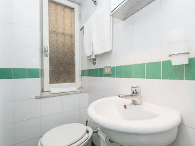 a white bathroom with a toilet and a sink at Spacious 2BR in the historic center in Rome