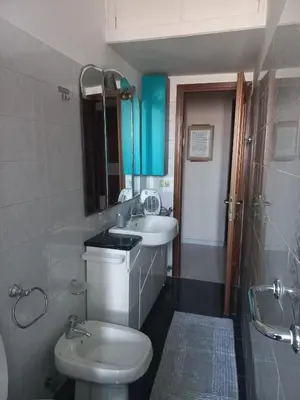 a bathroom with a white toilet and a sink at tommy's house in Rome