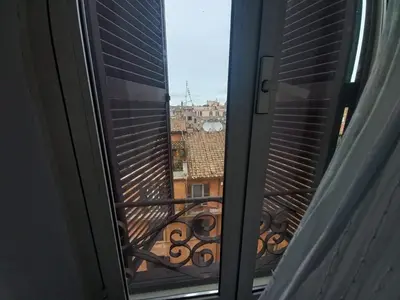 a window with a view of a city at tommy's house in Rome