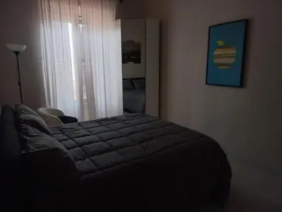a bedroom with a large bed in a room at tommy's house in Rome