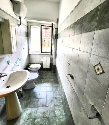a bathroom with two toilets and a sink at Da Zia Elena in Rome