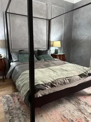 a bedroom with a canopy bed and a rug at Roma center home in Rome