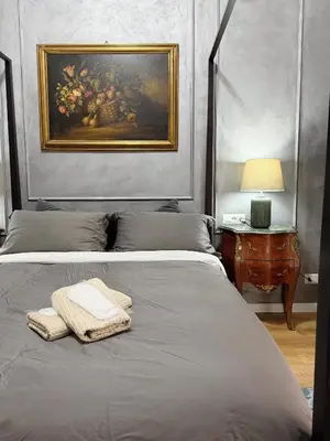 a bedroom with a bed with a painting on the wall at Roma center home in Rome
