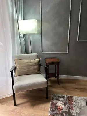 a chair with a pillow and a table in a room at Roma center home in Rome